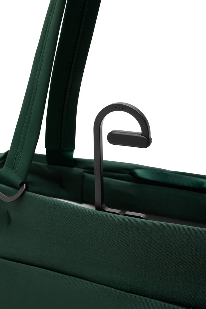 Close-up of a green suitcase with a handle on a white background