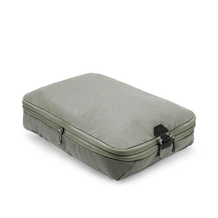Green travel case with zippers on a white background