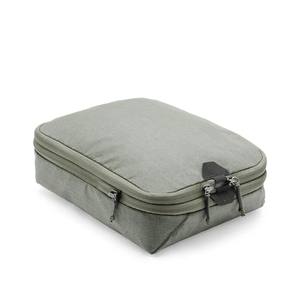 Green travel packing cube on a white background
