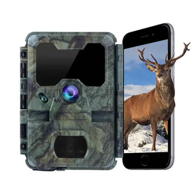 Camouflage trail camera with smartphone displaying a deer image on a white background