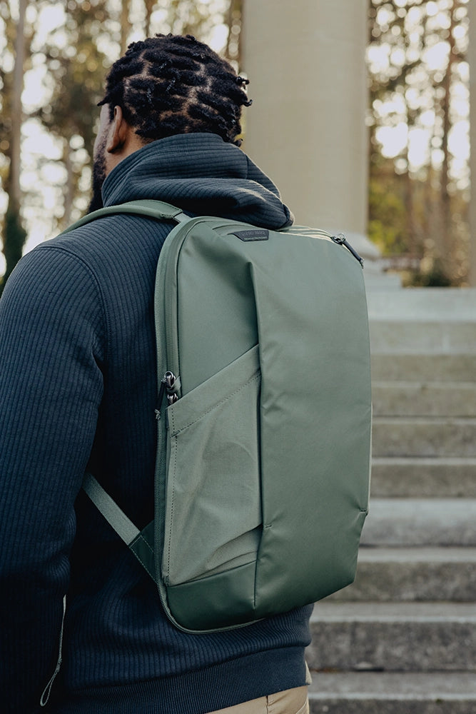 Person wearing a small green backpack outdoors