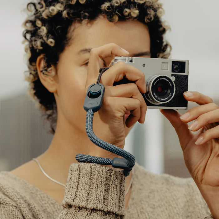 Person holding a vintage camera with a blurred background