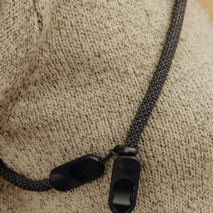 Close-up of a black strap with a clip on peak design system