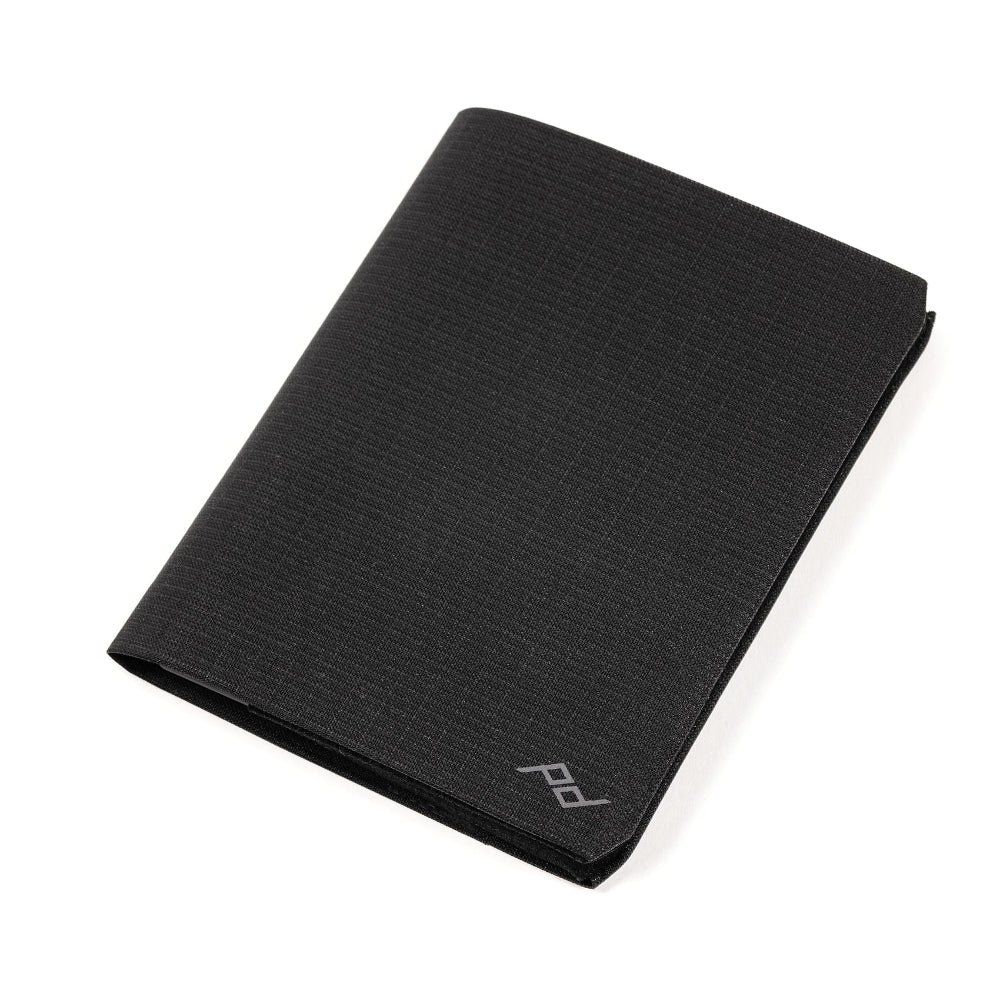 Black fabric wallet with a peak design logo on a white background