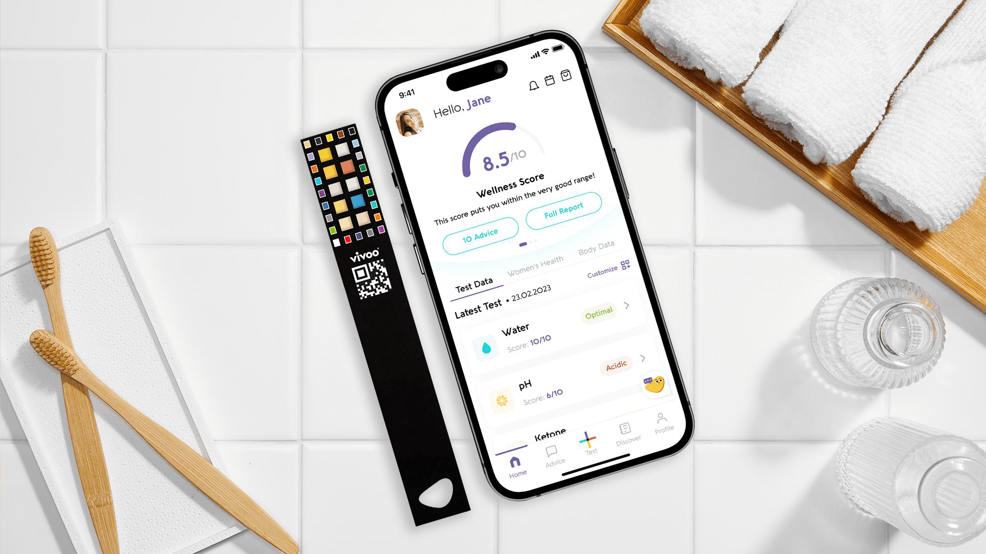 Smartphone displaying a health app on a white surface with urine test stick and other bathroom items.