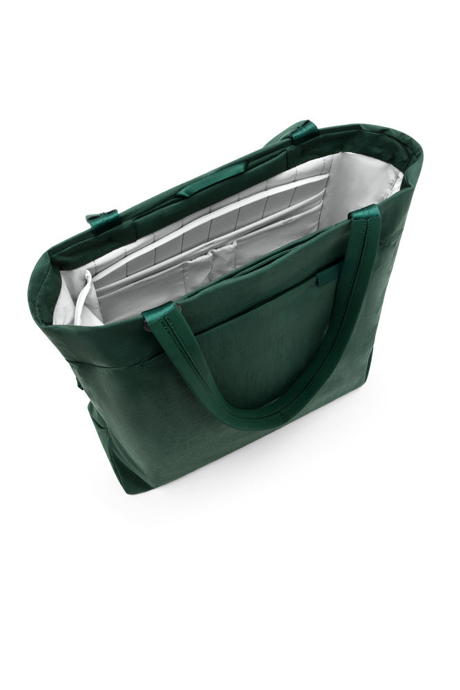 A dark green tote bag with a silver interior lining, shown from an elevated angle on a white background.