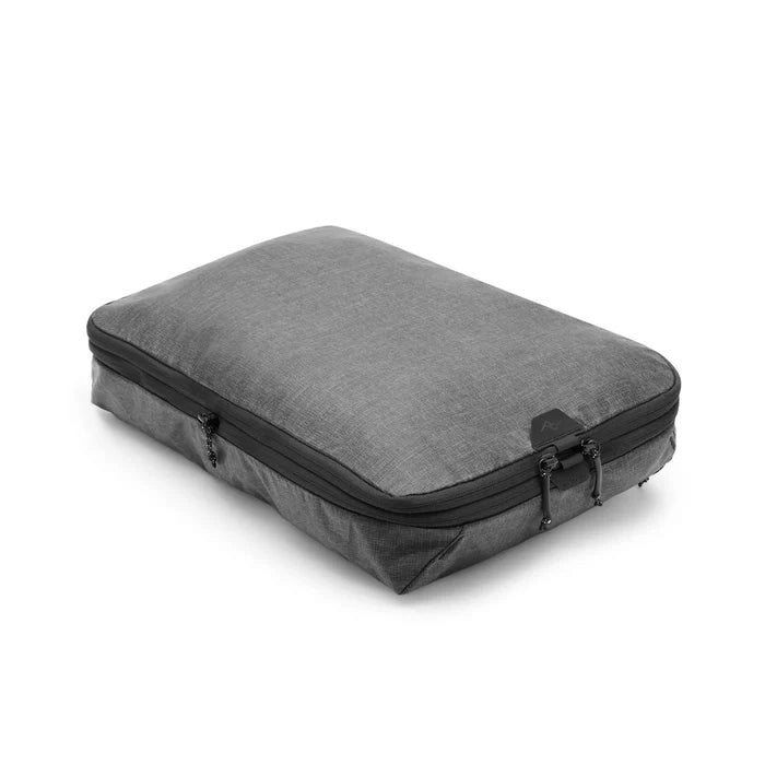 Gray travel packing cube with black zipper on a white background