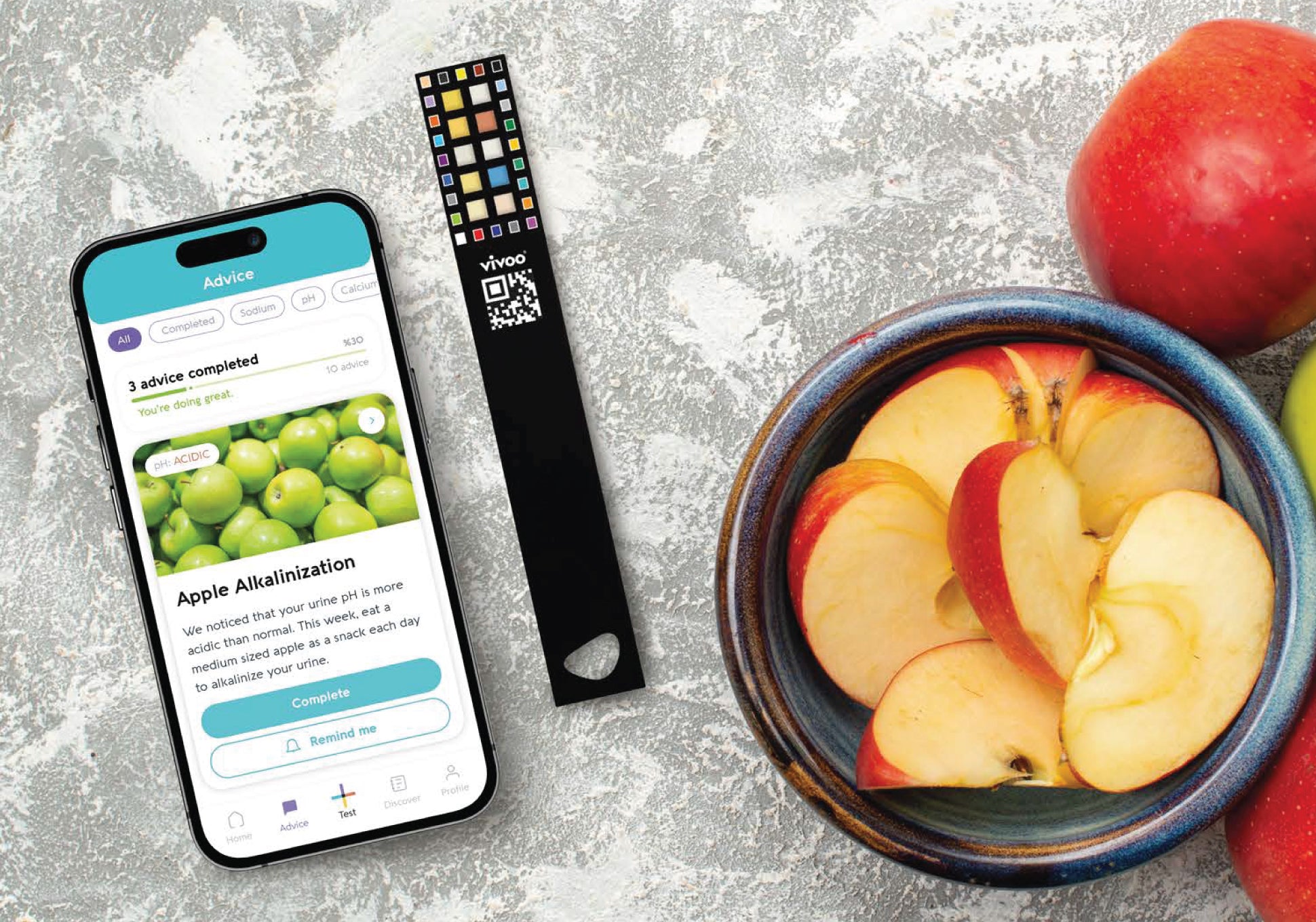 Phone with app interface, urine test stripe, and sliced apples on a textured surface
