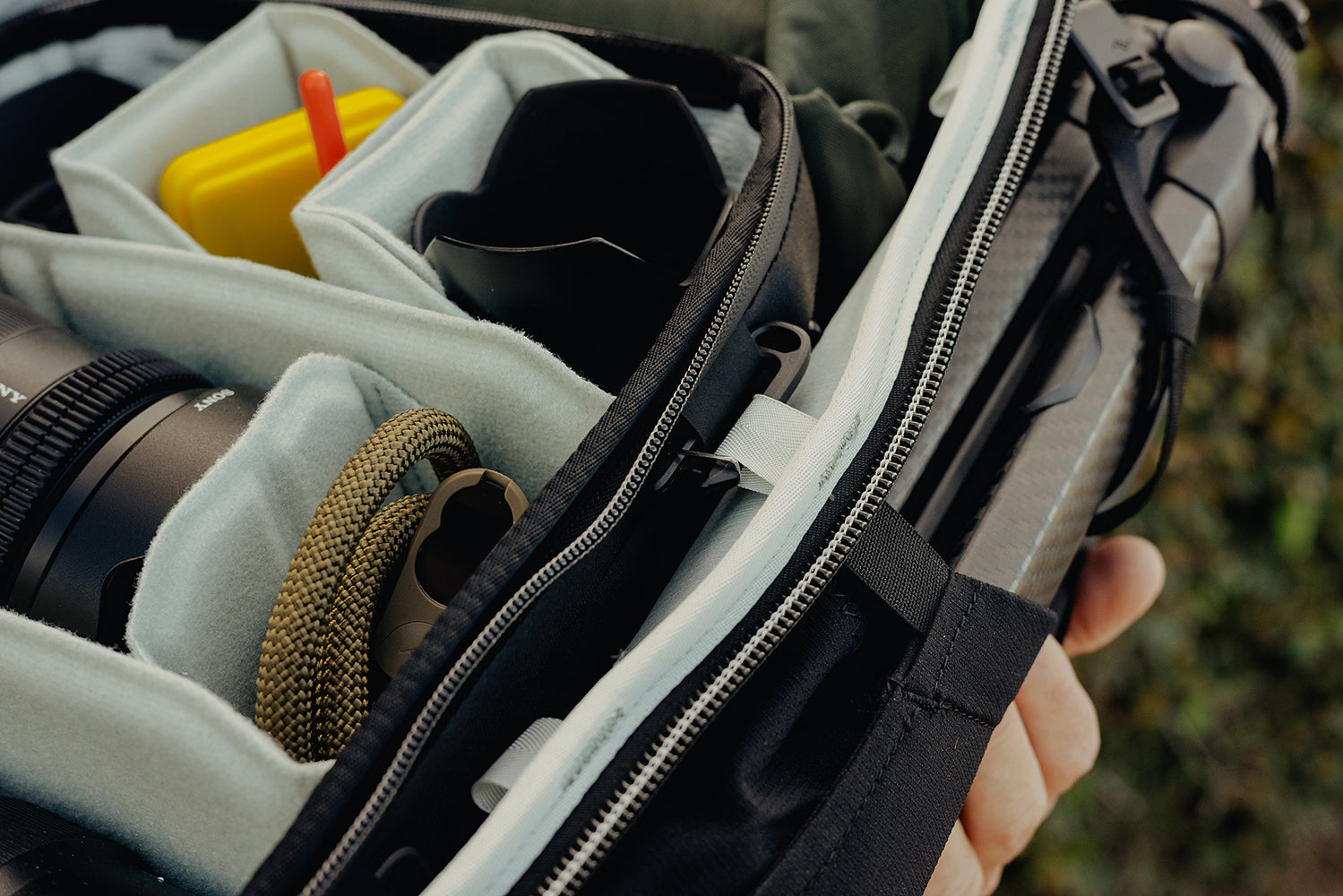 Camera equipment in a bag with a blurred natural background