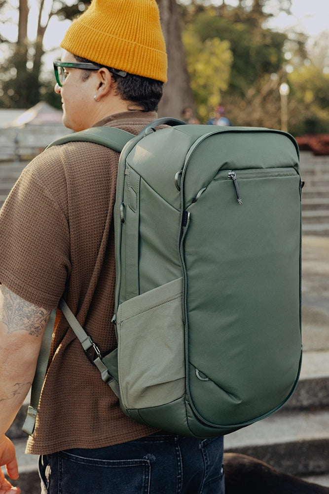 Person wearing a large green backpack outdoors