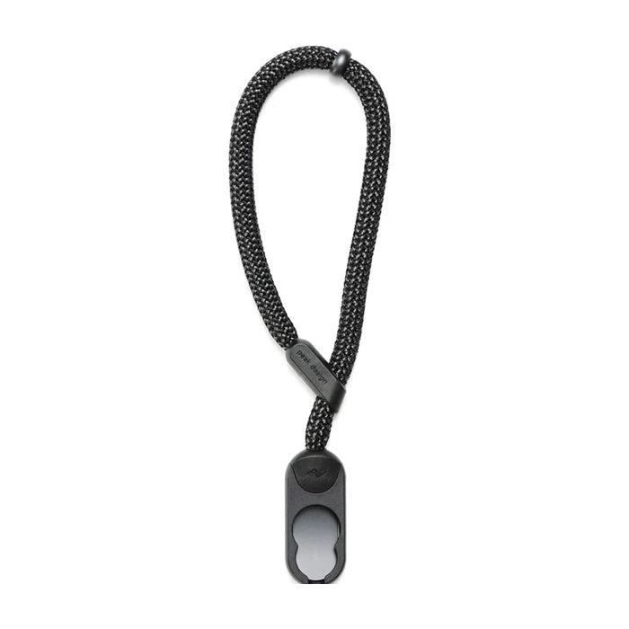 Black braided keychain with a metal tag on a white background
