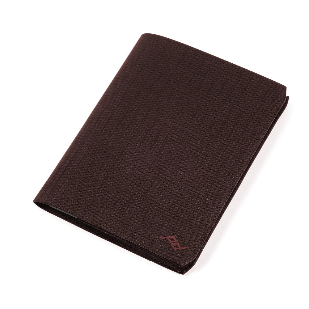 Brown fabric wallet with a peak design logo on a white background