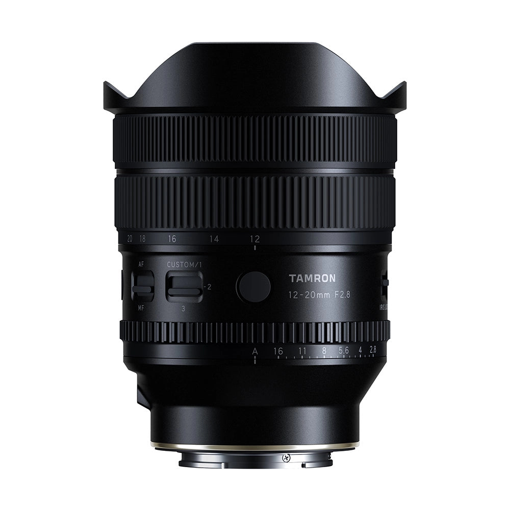 A black Tamron 12-20mm F2.8 lens with a petal-shaped lens hood, shown from the front against a solid white background.